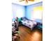 A well-lit bedroom with wood floors, complemented by a Black Panther-themed bedspread at 8357 Harrison Dr, Lawrence, IN 46226