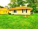 Well-kept single-story home with green lawn and detached garage at 8357 Harrison Dr, Lawrence, IN 46226