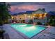 Backyard featuring a pool, covered patio, professional landscaping and outdoor lighting for evening enjoyment at 860 Chatham Hills Blvd, Westfield, IN 46074
