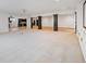 Expansive basement space with modern lighting and decorative pillars adjacent to the kitchen at 860 Chatham Hills Blvd, Westfield, IN 46074