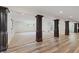 Finished basement showcasing decorative columns, new flooring, and an open layout for entertainment and recreation at 860 Chatham Hills Blvd, Westfield, IN 46074