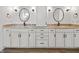 Bathroom featuring double sinks, vanity with granite countertops, mirrors, and modern fixtures at 860 Chatham Hills Blvd, Westfield, IN 46074