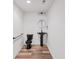 Contemporary half-bathroom with sleek black fixtures and wood-look flooring at 860 Chatham Hills Blvd, Westfield, IN 46074