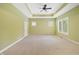 Spacious bedroom with tray ceiling, a ceiling fan, large windows, and neutral carpet at 860 Chatham Hills Blvd, Westfield, IN 46074
