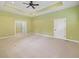 Spacious bedroom with tray ceiling, a ceiling fan, large windows, and neutral carpet at 860 Chatham Hills Blvd, Westfield, IN 46074