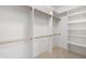 Bright walk-in closet with custom shelving and wooden rods for optimal organization and storage at 860 Chatham Hills Blvd, Westfield, IN 46074