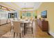 Dining room features wood floors, coffered ceilings, and an ornate chandelier at 860 Chatham Hills Blvd, Westfield, IN 46074