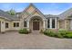 Charming entrance showcasing an arched entryway with double doors, manicured landscaping and a brick driveway at 860 Chatham Hills Blvd, Westfield, IN 46074