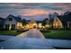 Beautiful twilight view of a home with a brick driveway, professional landscaping and inviting outdoor lighting at 860 Chatham Hills Blvd, Westfield, IN 46074
