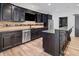 Kitchen features dark cabinets, stainless steel appliances, tile backsplash, and island at 860 Chatham Hills Blvd, Westfield, IN 46074