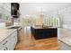 Open kitchen features granite island, stainless appliances and hood, and an open view to the living room at 860 Chatham Hills Blvd, Westfield, IN 46074