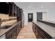 Kitchen features dark cabinets, stainless steel appliances, bar seating, and barn door at 860 Chatham Hills Blvd, Westfield, IN 46074