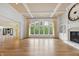 Bright living room featuring a fireplace, hardwood floors, large windows and coffered ceilings at 860 Chatham Hills Blvd, Westfield, IN 46074