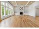 Open-concept living room with a fireplace, hardwood floors, large windows and coffered ceilings at 860 Chatham Hills Blvd, Westfield, IN 46074