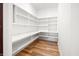 Walk-in pantry features white wood shelving and hardwood floors at 860 Chatham Hills Blvd, Westfield, IN 46074
