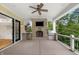 Outdoor patio features a brick fireplace, ceiling fan, stainless steel grill, and access to the backyard at 860 Chatham Hills Blvd, Westfield, IN 46074