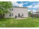 Grassy back yard features a basketball hoop, fire pit and back patio at 8712 Mellot Way, Camby, IN 46113