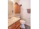 Bathroom with a wood vanity, a sink, and a hanging cabinet at 8712 Mellot Way, Camby, IN 46113