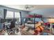 Bedroom with blue walls, wood floor, a bunk bed and an office area at 8712 Mellot Way, Camby, IN 46113