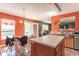 Eat-in kitchen featuring an island, wood cabinets, wood floors, and a breakfast area at 8712 Mellot Way, Camby, IN 46113