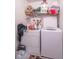 Functional laundry room area including a washer, dryer, and overhead storage shelf at 8712 Mellot Way, Camby, IN 46113