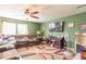 The living room showcases a fireplace, a ceiling fan, and a large window, creating a relaxing space at 8712 Mellot Way, Camby, IN 46113