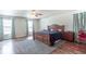 Spacious main bedroom featuring hardwood floors, a ceiling fan, and three large windows at 8712 Mellot Way, Camby, IN 46113