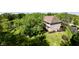 Aerial view of the home showcasing mature trees, lush green lawns and large backyard pond at 897 Copperwood Dr, Carmel, IN 46033