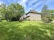 Expansive backyard featuring lush green lawn, mature trees, and home exterior at 897 Copperwood Dr, Carmel, IN 46033
