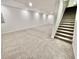 Spacious basement with neutral carpet, white walls, and stairs leading to the upper level at 897 Copperwood Dr, Carmel, IN 46033