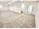 Large basement area with neutral carpeting, white walls, and an open doorway at 897 Copperwood Dr, Carmel, IN 46033