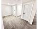 Basement view with carpet, white walls, door, and view into the bathroom at 897 Copperwood Dr, Carmel, IN 46033