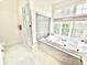 Elegant bathroom featuring a luxurious bathtub, glass shower, and natural light at 897 Copperwood Dr, Carmel, IN 46033