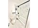Modern bathroom featuring marble tiling, black accents, and stylish fixtures at 897 Copperwood Dr, Carmel, IN 46033