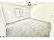 Bright bedroom with neutral carpet, ceiling fan and window at 897 Copperwood Dr, Carmel, IN 46033