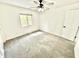 Bright bedroom with neutral carpet, ceiling fan and window at 897 Copperwood Dr, Carmel, IN 46033