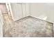 Bedroom area with neutral carpeting, white walls, and a double closet at 897 Copperwood Dr, Carmel, IN 46033