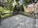 Spacious outdoor wooden deck surrounded by lush greenery and trees perfect for relaxation at 897 Copperwood Dr, Carmel, IN 46033