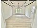 Elegant dining room with modern light fixture, wainscoting, and hardwood floors creates an ideal space for gatherings at 897 Copperwood Dr, Carmel, IN 46033