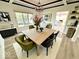 Stylish dining room with wood floors, modern light fixture and contemporary table and chairs at 897 Copperwood Dr, Carmel, IN 46033