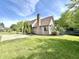 Well-maintained exterior with brick chimney, manicured lawn, and beautiful landscaping at 897 Copperwood Dr, Carmel, IN 46033
