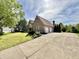 Exterior view of a home with a long concrete driveway leading to a two-car garage in a suburban neighborhood at 897 Copperwood Dr, Carmel, IN 46033