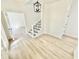 Bright foyer with beautiful hardwood floors, staircase with decorative carpet, and a modern light fixture at 897 Copperwood Dr, Carmel, IN 46033