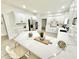 Bright kitchen with white cabinets, island with seating and stainless steel appliances at 897 Copperwood Dr, Carmel, IN 46033