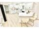 Open kitchen with white cabinets, quartz countertops and adjacent bar seating at 897 Copperwood Dr, Carmel, IN 46033