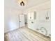 Bright laundry room with white cabinets and a modern light fixture at 897 Copperwood Dr, Carmel, IN 46033
