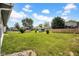 Spacious backyard featuring green grass, storage sheds, and a wood fence at 905 Congressional Way, Shelbyville, IN 46176