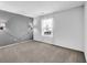 Bedroom featuring modern wall sconces, neutral color, and window providing ample natural light at 905 Congressional Way, Shelbyville, IN 46176