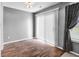 Small bedroom featuring hardwood floors, a large window, and dark modern curtains at 905 Congressional Way, Shelbyville, IN 46176