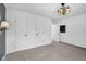 Neutral bedroom showcasing two doors to closets, a door to bath, and modern lighting at 905 Congressional Way, Shelbyville, IN 46176